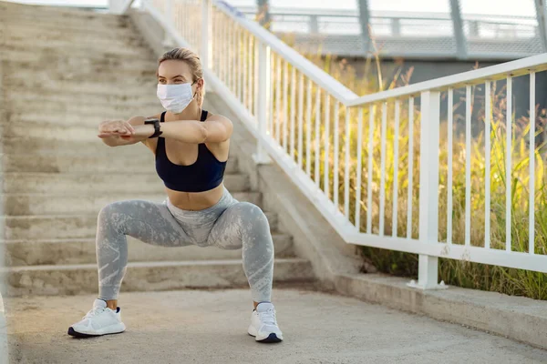 Female Athlete Wearing Protective Face Mask While Doing Squats Working — Photo