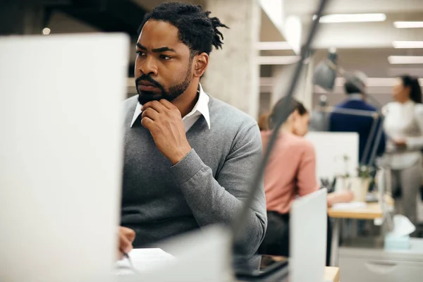 Black Businessman Reading Data Writing Notes While Working Corporate Office — Foto de Stock