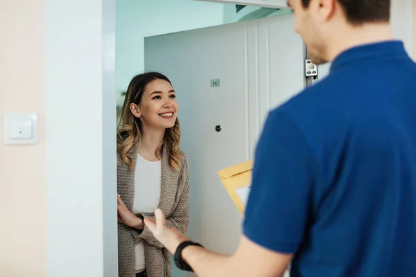 Young Happy Woman Talking Delivery Man While Receiving Package Home — Foto Stock