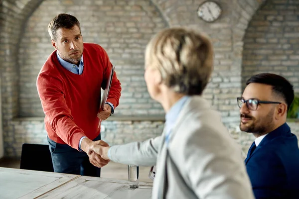 Mid Adult Businessman Shaking Hands Colleagues While Having Meeting Office — Fotografia de Stock