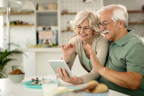 Happy Mature Couple Using Digital Tablet Waving While Having Video — 스톡 사진