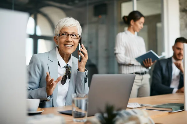 Happy Senior Businesswoman Talking Cell Phone While Working Laptop Office — Stock Fotó