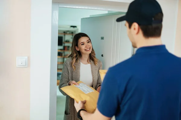 Happy Woman Taking Package Courier While Receiving Home Delivery — Zdjęcie stockowe