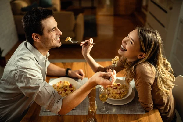 Happy Couple Having Fun While Feeding Each Other Meal Dining — стоковое фото