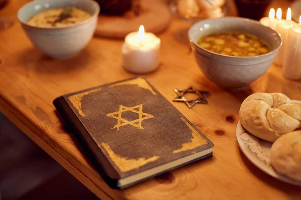 Hebrew bible on dining table during Hanukkah at home.