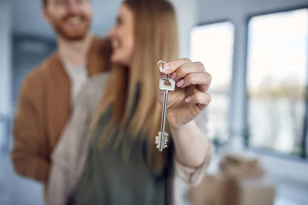 Close-up of couple holding door key of their new house.