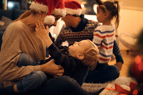 Joyful Mother Playing Her Small Son While Celebrating Christmas Eve — Zdjęcie stockowe