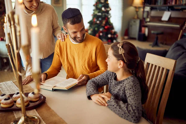 Happy Jewish Parents Daughter Talking While Reading Tanakh Hanukkah Home — Stockfoto