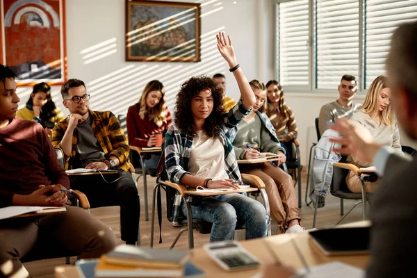 Smiling Female Student Raising Arm Answer Teacher Question Lecture Classroom — Stockfoto