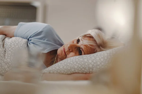 Pensive Senior Woman Lying Bed Thinking Something — Stockfoto