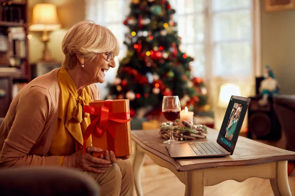 Happy Senior Woman Holding Christmas Present While Talking Her Son — Photo