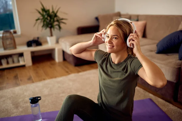Happy Athletic Woman Using Headphones While Relaxing Home Sports Training —  Fotos de Stock
