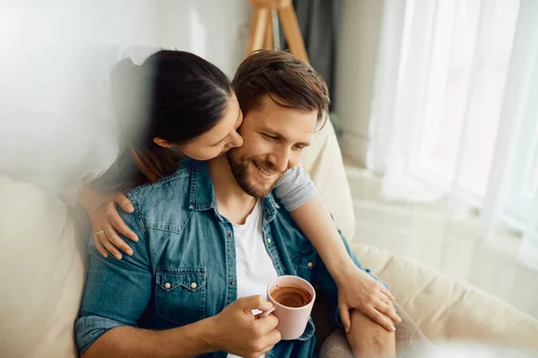 Happy Man Enjoying Cup Coffee His Wife While She Embracing — Zdjęcie stockowe