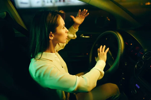 Young Woman Feeling Frustrated Honking While Driving Car Night — Stockfoto