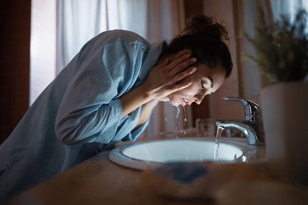 Young Woman Washing Her Face Bathroom Night — Zdjęcie stockowe