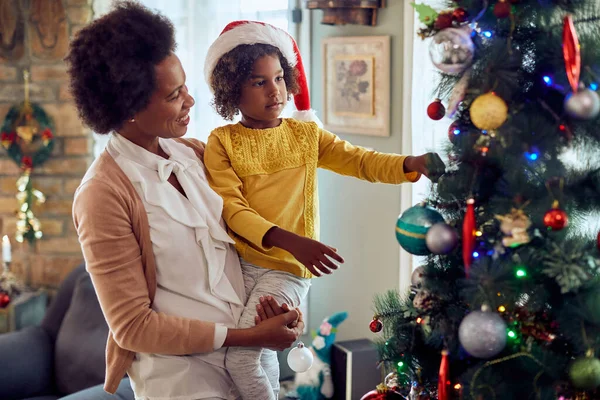 Happy African American Mother Enjoying While Decorating Christmas Tree Her — ストック写真