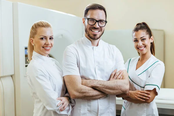 Group Happy Confident Healthcare Experts Standing Arms Crossed Hospital Looking — Stockfoto