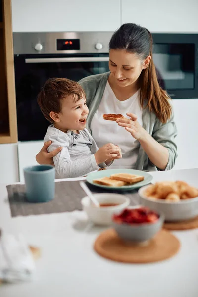 Happy Little Boy Having Breakfast Mother Dining Table Home — стоковое фото