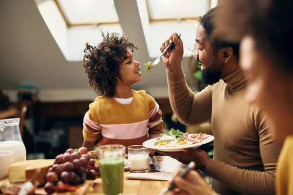 Happy Black Girl Having Fun While Being Fed Her Father — Foto de Stock