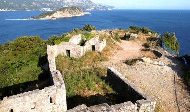 ruins of an ancient fortress on a high cliff, montenegro, surroundings of the city of Budva, sky, Jadran sea, forest