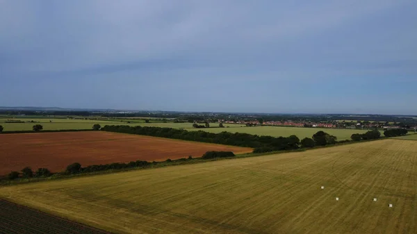 Renewable Solar Panel Power and Windmill Wind Turbine Farms at England, High Angle Aerial view of Drone\'s Footage
