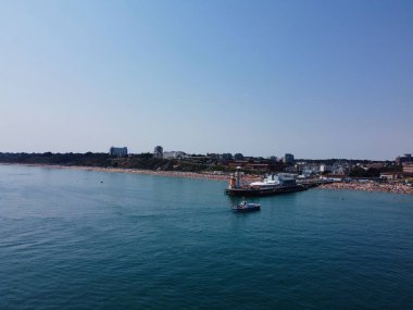 High Angle Footage and Aerial view of Ocean with High Speed Boats, People are having fun and enjoying hottest weather at Bournemouth Beach Sea Front of England UK.