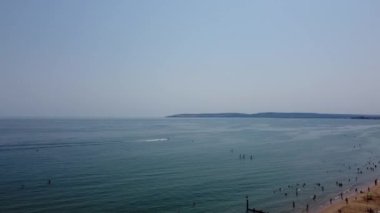 Aerial view of Fast, Racing and Sports Boats in the Ocean, High Angle footage of Beach of Bournemouth City of England UK