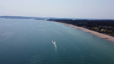 Aerial view of Fast, Racing and Sports Boats in the Ocean, High Angle footage of Beach of Bournemouth City of England UK