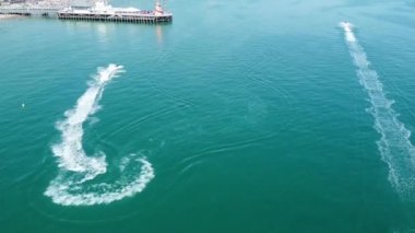Aerial view of Fast, Racing and Sports Boats in the Ocean, High Angle footage of Beach of Bournemouth City of England UK