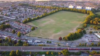 High Angle Aerial Footage View of Train and Railway Tracks at Sunset Time over Luton Town of England UK