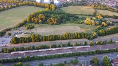 High Angle Aerial Footage View of Train and Railway Tracks at Sunset Time over Luton Town of England UK