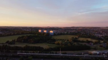 High Angle Aerial Footage View of Train and Railway Tracks at Sunset Time over Luton Town of England UK