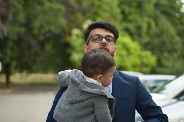 Asian Pakistani Father is holding his 11 Months Old Infant at Local Park of London Luton England UK