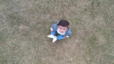 11 Months old Cute Baby is Enjoying and Posing to Camera at Park of Luton England UK