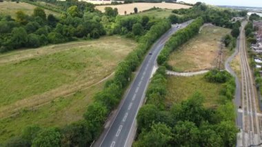 High Angle aerial view of  British Roads and Traffic Passing through Luton City and countryside of England UK