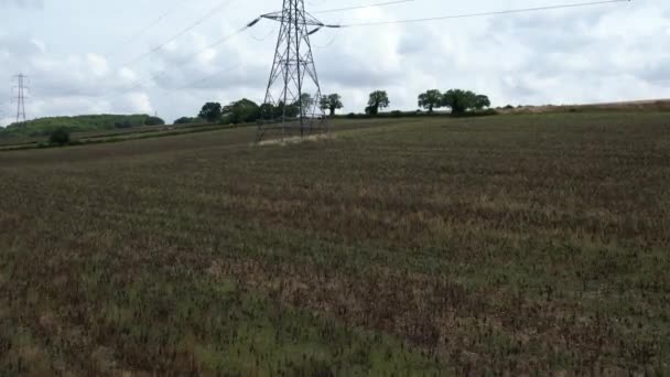 High Voltage Power Supply Poles Cables Running British Farmlands Countryside — Stock video