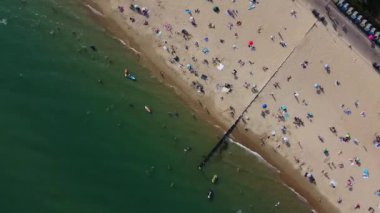 People are enjoying and relaxing at Bournemouth sandy Beach of England UK, beautiful British Sea View and Clean Ocean of Great Britain