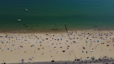 People are enjoying and relaxing at Bournemouth sandy Beach of England UK, beautiful British Sea View and Clean Ocean of Great Britain