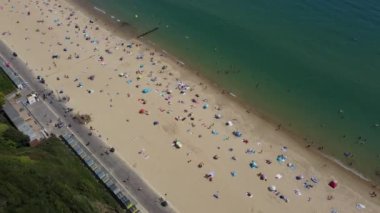 People are enjoying and relaxing at Bournemouth sandy Beach of England UK, beautiful British Sea View and Clean Ocean of Great Britain
