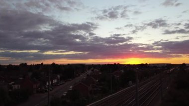 Train moving on Tracks at Sunset Time, the footage was captured at Leagrave Luton Station of England at a Beautiful Sunset Time, Trains is Passing from British City