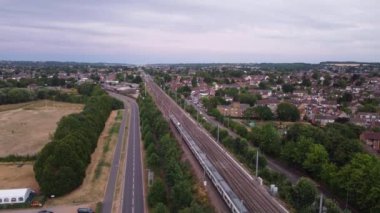 Train moving on Tracks at Sunset Time, the footage was captured at Leagrave Luton Station of England at a Beautiful Sunset Time, Trains is Passing from British City