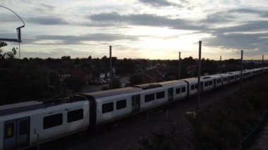 Train moving on Tracks at Sunset Time, the footage was captured at Leagrave Luton Station of England at a Beautiful Sunset Time, Trains is Passing from British City