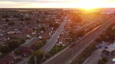 Train moving on Tracks at Sunset Time, the footage was captured at Leagrave Luton Station of England at a Beautiful Sunset Time, Trains is Passing from British City