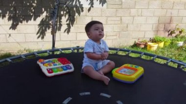 Cute Asian Pakistani Baby Boy Posing  and playing, 11 months old baby is playing in the garden with his grand dad