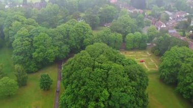 Aerial and High Angle Footage of Local Public Park on a Cloudy Day,  Wardown Park is situated on the River Lea in Luton. The park has various sporting facilities, is home to the Wardown Park Museum.