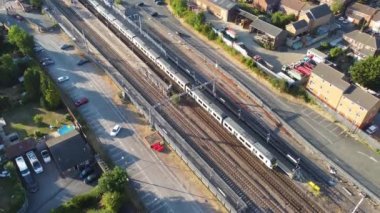 Aerial view of British Town Centre of Luton England with Railway Station and Train on Track