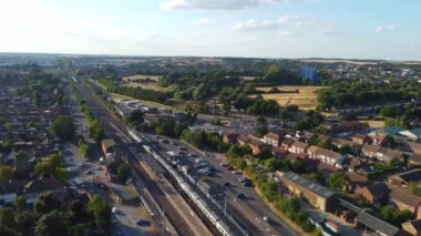 Aerial view of British Town Centre of Luton England with Railway Station and Train on Track