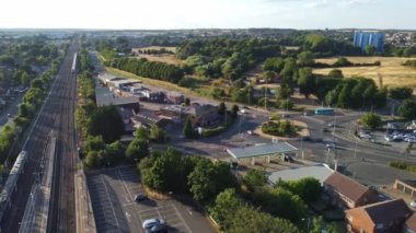 Aerial view of British Town Centre of Luton England with Railway Station and Train on Track