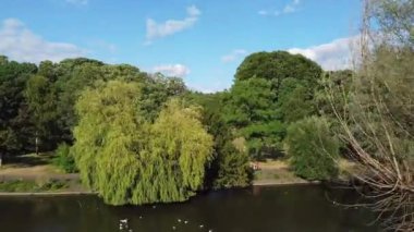 Water Birds are Swimming in the Lake Water of Local Public Park of Luton England Great Britain on a hot Day of Summer 2022, Drone's Camera Footage.