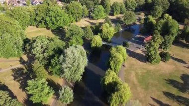 Water Birds are Swimming in the Lake Water of Local Public Park of Luton England Great Britain on a hot Day of Summer 2022, Drone's Camera Footage.